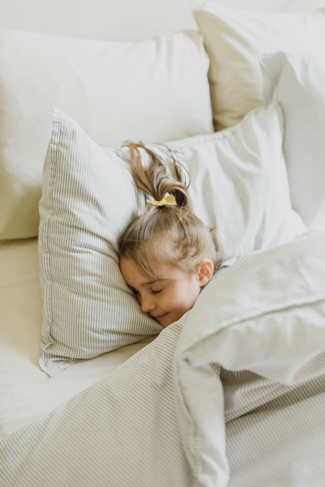 Criança dormindo tranquila na cama