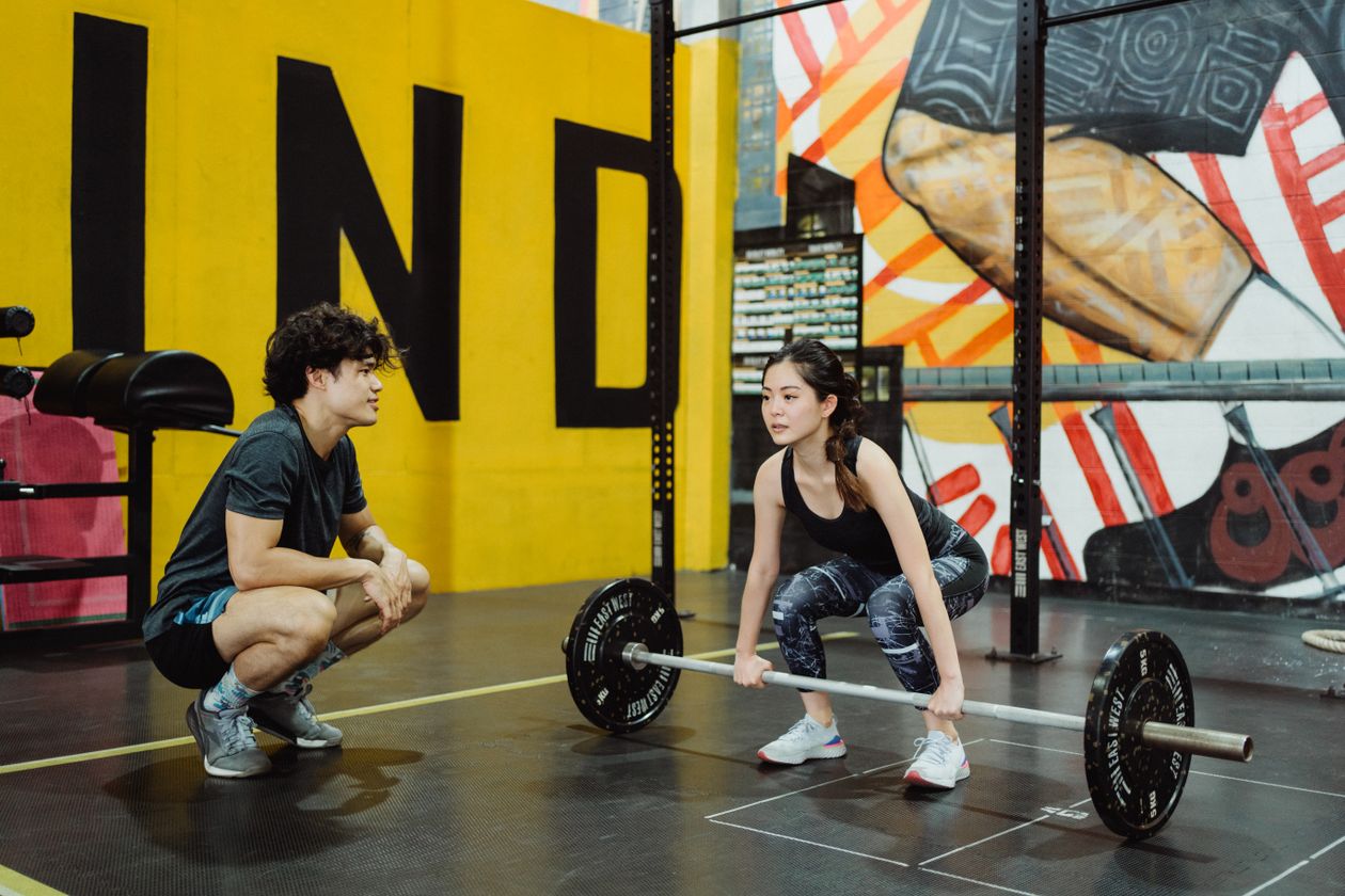 Mulher treinando musculação na academia com tênis Olympikus feminino, contexto de tênis olympikus feminino para academia