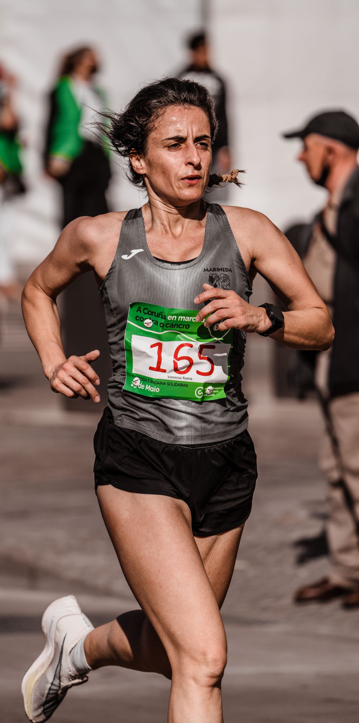 Mulher atleta correndo em corrida de rua, contexto de tênis asics para corrida feminino